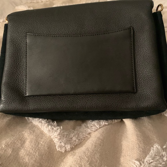 Tory Burch—100% leather. This bag has lots of room, three pockets. - Picture 7 of 10